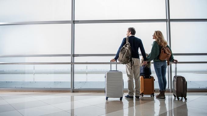 image of couple moving abroad in airport